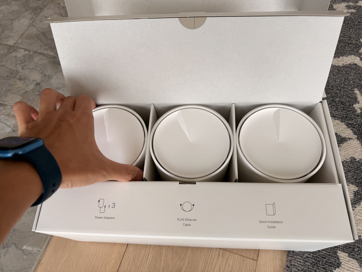New three-node mesh router kit being unboxed